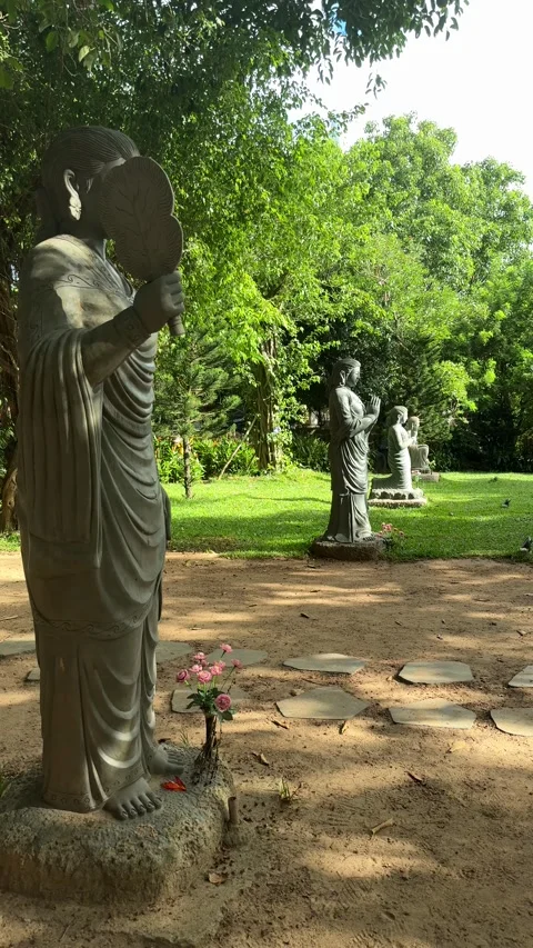 Da nang, lady buddha, row of stone buddhist monk sculptures standing in a green Stock Footage 340189120