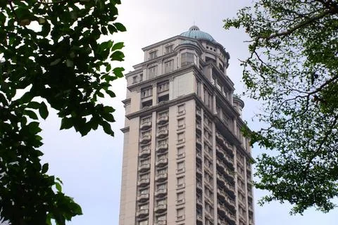 Da Vinci Tower Copper Dome Framed by Tropical Tree Branches in Jakarta Stock Photos
