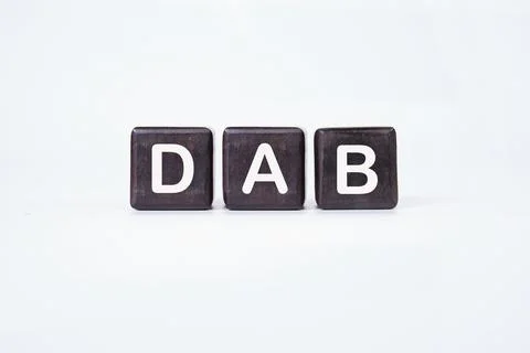 DAB text on dark cubes on a light background. Stock Photos