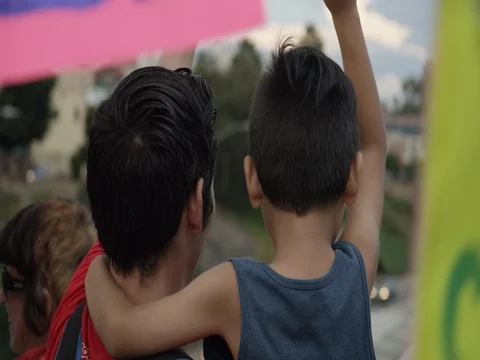 DACA supporter (father and son) during march from Echo Park Lake to Olvera in Stock Footage 81574660