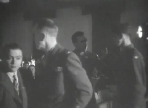 DACHAU, GERMANY - 1947: Patterned tie - Young man crosses crowded hall Stock Footage 344490899