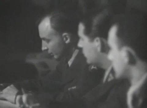 DACHAU, GERMANY - 1947: Table notes - Uniformed man writes beside servicemen Stock Footage 344490830
