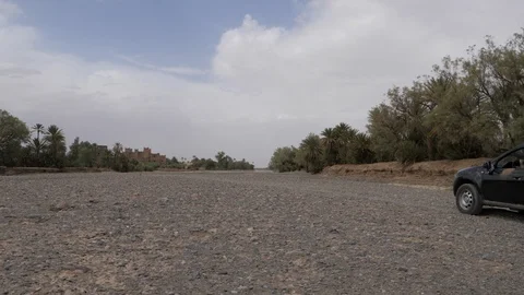 Dacia duster runs in Dades river bed, Morocco, Africa in 4K Stock Footage 91868756