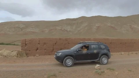 Dacia Duster runs in Morocco hinterlands near Dades, Africa in 4K Stock Footage 91860830