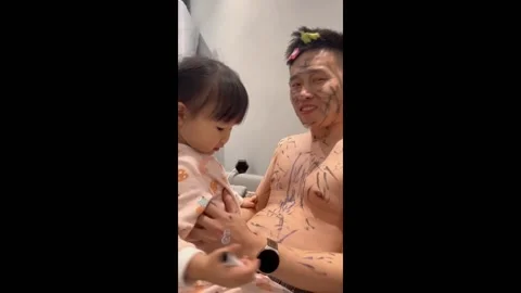 Dad adorned with black marker scribbles in Changchun, China Video stock 277192700