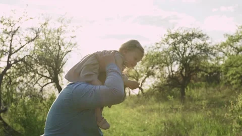 Dad and 2 year old child, have fun in the garden Stock Footage 131252655