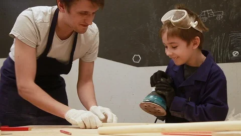 Dad and Boy have fun working with the grinding machine Stock Footage 102241166