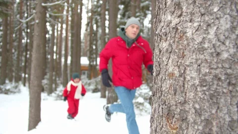 Dad and boy play catch-up in winter. Slowmotion Stock Footage 129095059