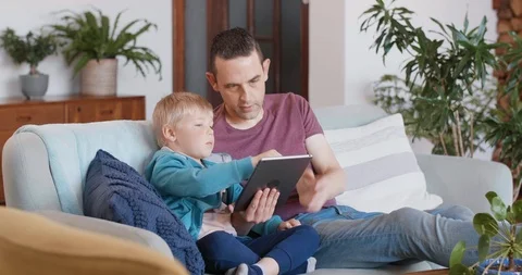Dad and child using technology device Stock Footage 120345546