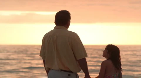 Dad and daugher talking on the beach Stock Footage 1003251