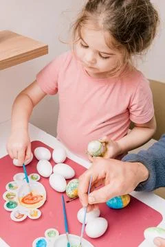 Dad and daughter drawing Easter eggs, man and girl spend time together for .. Stock-Fotos