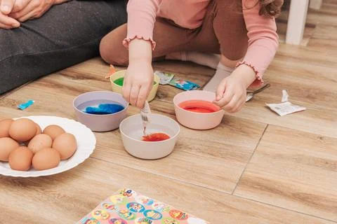 Dad and daughter drawing Easter eggs, man and girl spend time together for .. Stock Photos