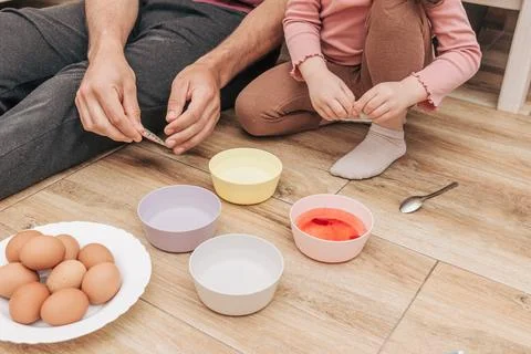Dad and daughter drawing Easter eggs, man and girl spend time together for .. Stock Photos