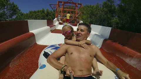 Dad and daughter go down the water slide Stock-Footage 64149908
