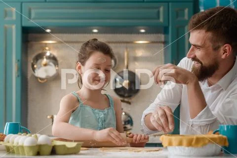 Dad and daughter having fun in the kitchen Stock Photos