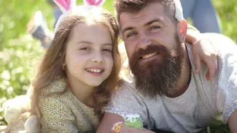 Dad and daughter sits on grass at grassp... | Stock Video | Pond5