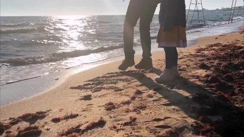 Dad and daughter spend time together on the beach by the sea on a sunny day Stock Footage 228904073