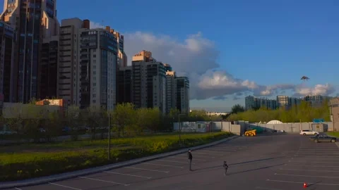 Dad and his son fly a kite. Drone flight over the city at sunset. Video stock 131095599