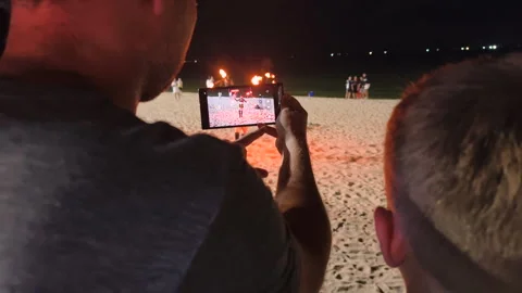 A dad and his son viewing a fire performance at the beach. Stock Footage 317812910