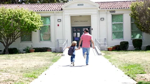 Dad and kid hurrying to school, slow motion, parenthood. Vidéo