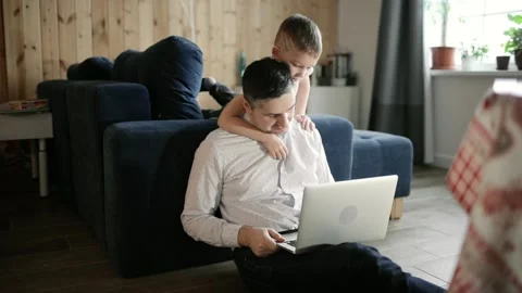 Dad and son are doing homework together on laptop, distance education, lockdown. Stock Footage 146841281