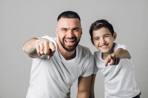 Dad and son are indicating to the camera Stock Photos