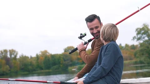 Dad and son communicate on the fishing Stock Footage 80840149