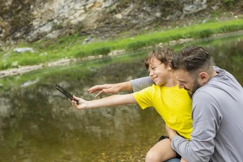 Dad and son having fun outdoors, playing in summer day Stock Photos