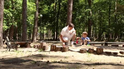 Dad and son play in the sandbox Stock Footage 65154567