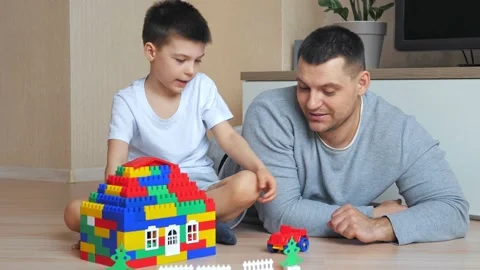 Dad and son playing in the constructor. Self-isolation concept for fighting Stock Footage 149585066