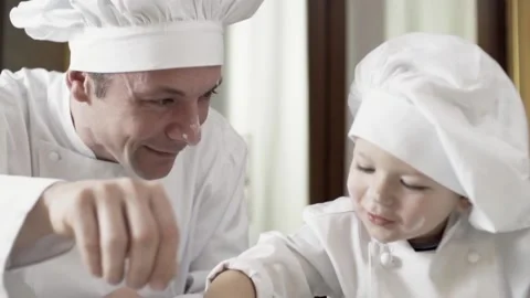 Dad and son playing with flour while cooking cake. Family activities, son learn 動画素材 155830940