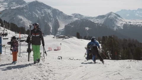 Dad and son Skiing, young ski racers pass, snowy swiss alp mountains and pine Stock Footage 183352746