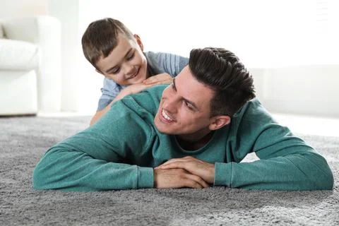 Dad and son spending time together at home. Happy Father's Day Stock Photos