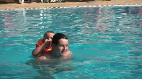 Dad and son swim in the pool Stock Footage 668643