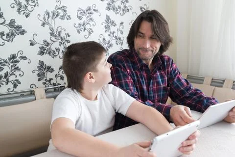 Dad and son   with tablet computer indoor Stock Photos