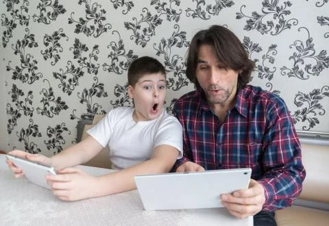Dad and son   with tablet computer indoor Stock Photos