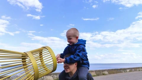 Dad and son throw the plastic bottle into the plastic collection container. Recy Video stock 153525658