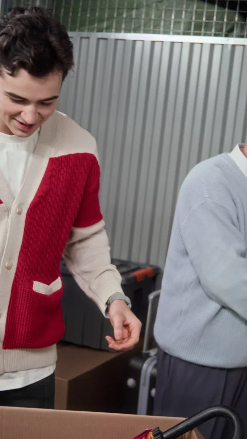 Dad and Son Unpacking Badminton and Ping Pong Rackets from Storage Box Stock Footage 327787953