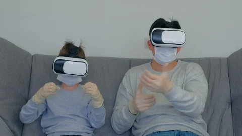 Dad and son using virtual reality glasses in coronavirus pandemic quarantine. Stock Footage 128985550