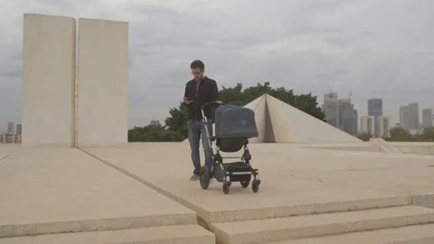 Dad and stroller - Dad letting go of stroller - Long shot Stock Footage 77003942