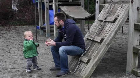 Dad and toddler at park on the play gym Stock Footage 59125156