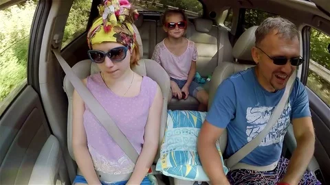 Dad and two daughters go to Ai-Petri mountain by car, dad talks while driving Stock Footage 73378720