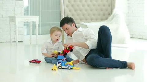 Dad and young son playing cars on the floor. Stock Footage 62344660
