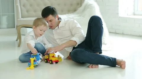 Dad and young son playing cars on the floor. Stock-Footage 62345650