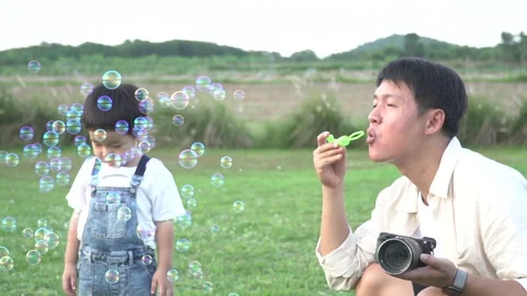 Dad blow bubble for son slow motion Stock Footage 202211272