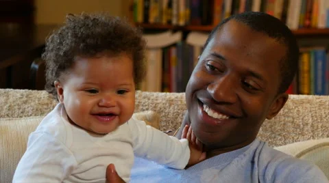Dad bouncing daughter on his lap Stock Footage 53007209