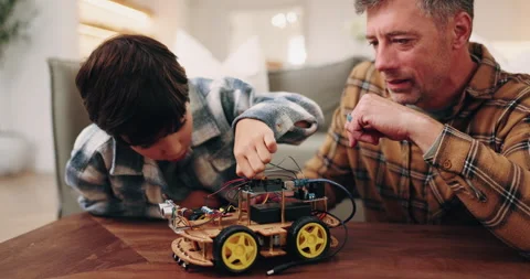 Dad, boy and building with toy car in home for assembling parts, bonding or fun Stock Footage 338170427