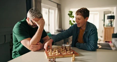 Dad, boy and play chess in home for cognitive development, challenge and Stock Footage 314372359