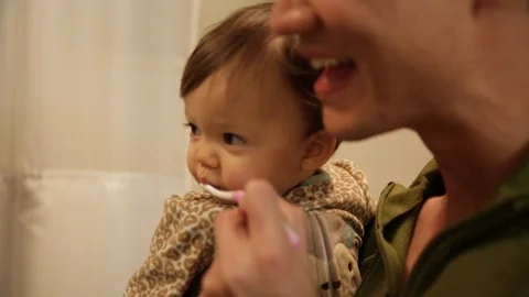 Dad Brushing Little Baby's Teeth Before Bedtime Stock Footage