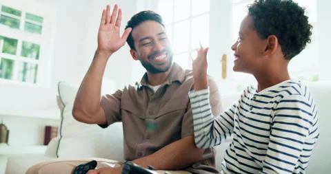 Dad, child and playing video game with high five in home for winning or fair Stock Footage 343637936